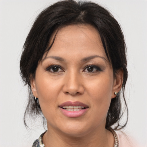Joyful asian adult female with medium  brown hair and brown eyes