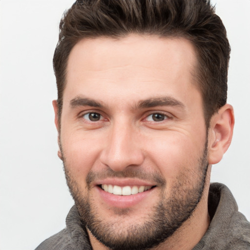 Joyful white young-adult male with short  brown hair and brown eyes