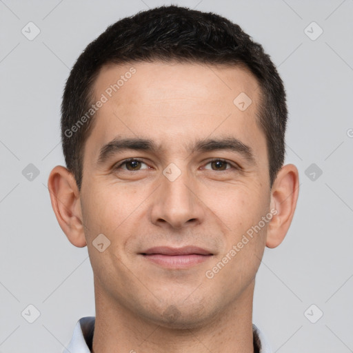 Joyful white young-adult male with short  brown hair and brown eyes