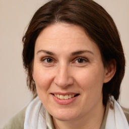 Joyful white adult female with medium  brown hair and brown eyes