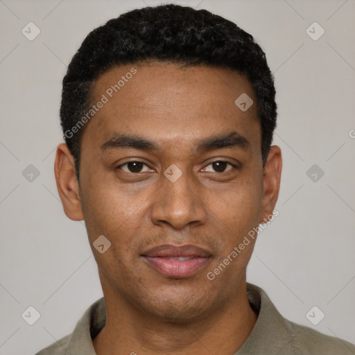 Joyful black young-adult male with short  black hair and brown eyes