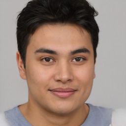 Joyful asian young-adult male with short  brown hair and brown eyes