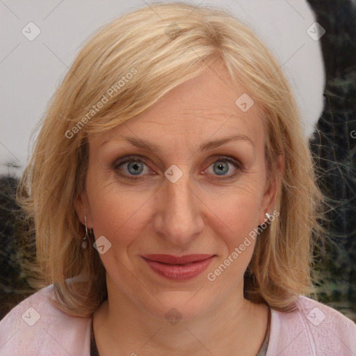 Joyful white adult female with medium  brown hair and blue eyes