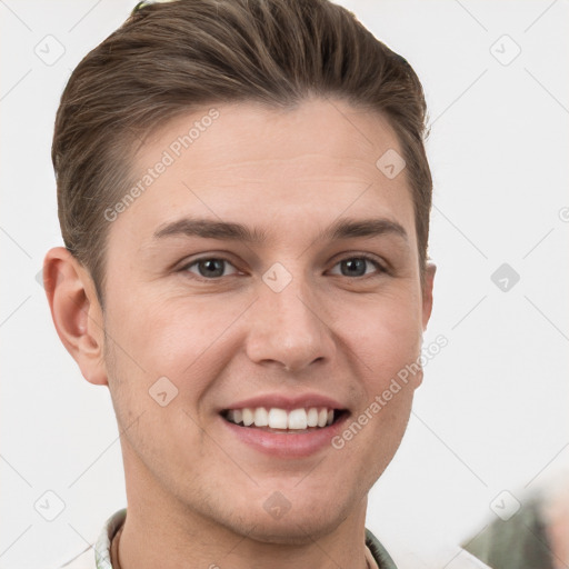 Joyful white young-adult male with short  brown hair and grey eyes