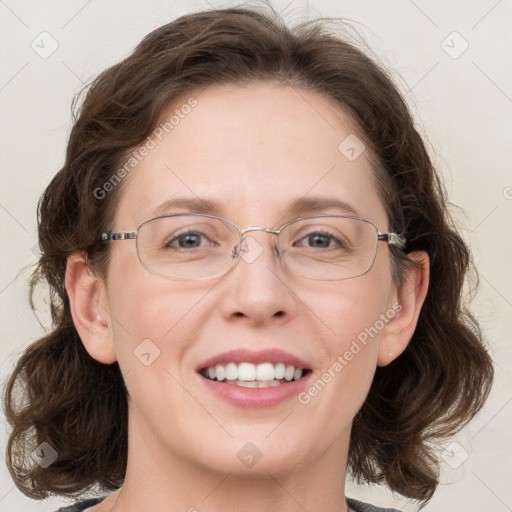 Joyful white adult female with medium  brown hair and blue eyes