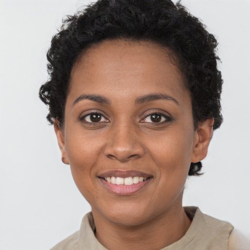 Joyful black young-adult female with short  brown hair and brown eyes
