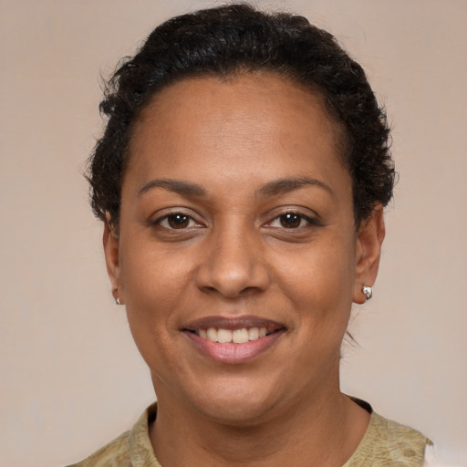 Joyful latino adult female with short  brown hair and brown eyes