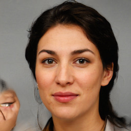 Joyful white adult female with medium  brown hair and brown eyes