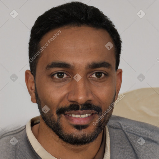 Joyful black young-adult male with short  black hair and brown eyes