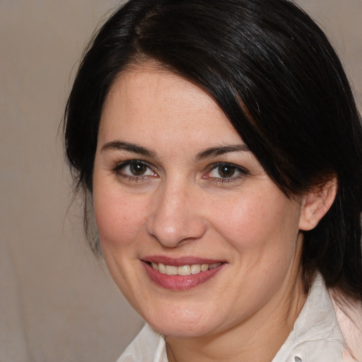 Joyful white adult female with medium  brown hair and brown eyes