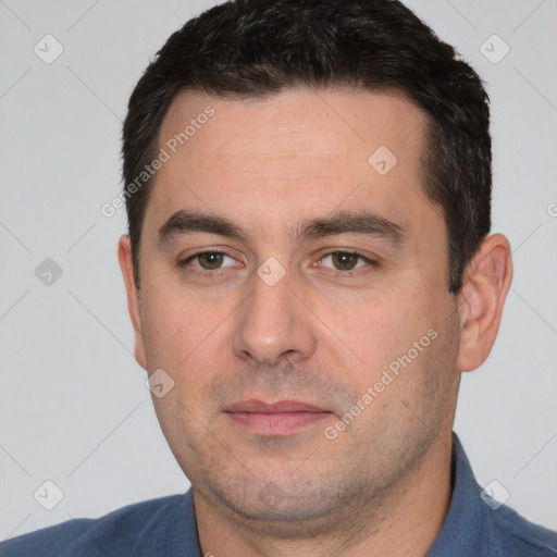 Joyful white young-adult male with short  black hair and brown eyes