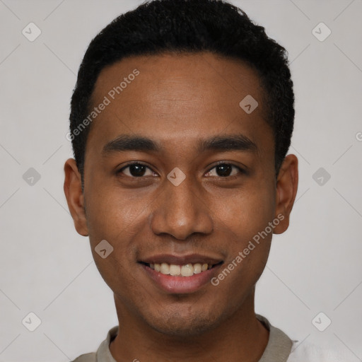 Joyful black young-adult male with short  black hair and brown eyes