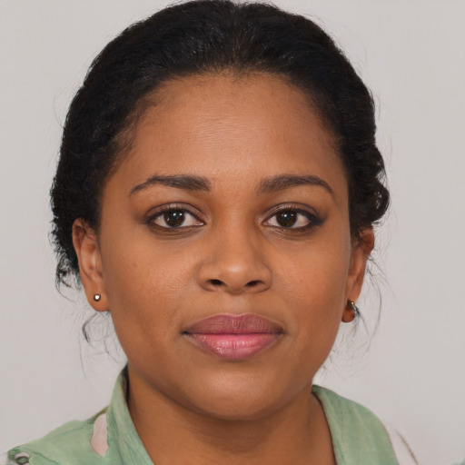 Joyful black young-adult female with medium  brown hair and brown eyes