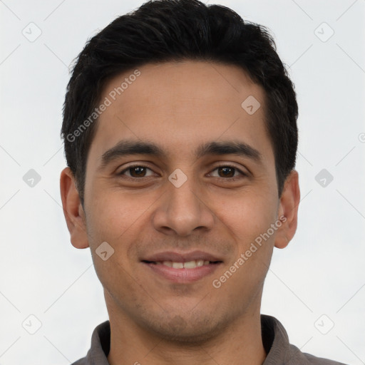 Joyful latino young-adult male with short  brown hair and brown eyes