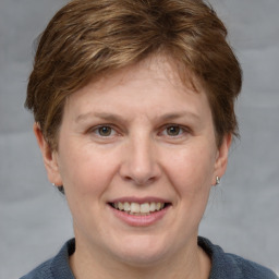 Joyful white adult female with short  brown hair and grey eyes