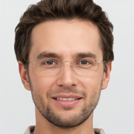 Joyful white adult male with short  brown hair and brown eyes