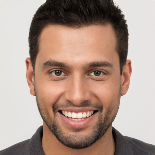 Joyful white young-adult male with short  brown hair and brown eyes