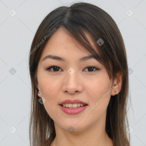 Joyful asian young-adult female with long  brown hair and brown eyes