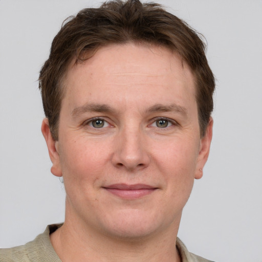 Joyful white adult male with short  brown hair and grey eyes