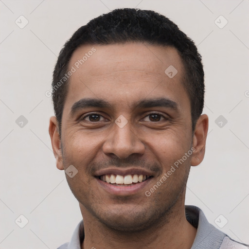 Joyful latino young-adult male with short  black hair and brown eyes