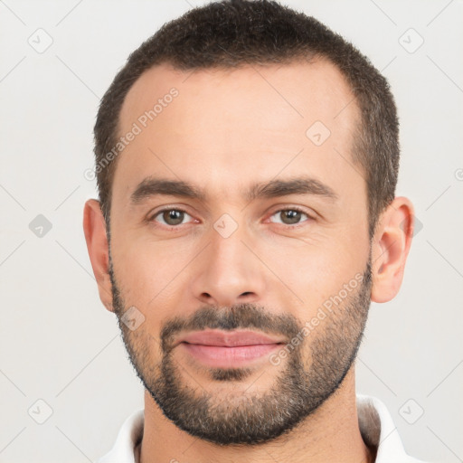 Joyful white young-adult male with short  black hair and brown eyes