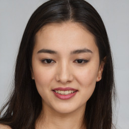 Joyful asian young-adult female with long  brown hair and brown eyes