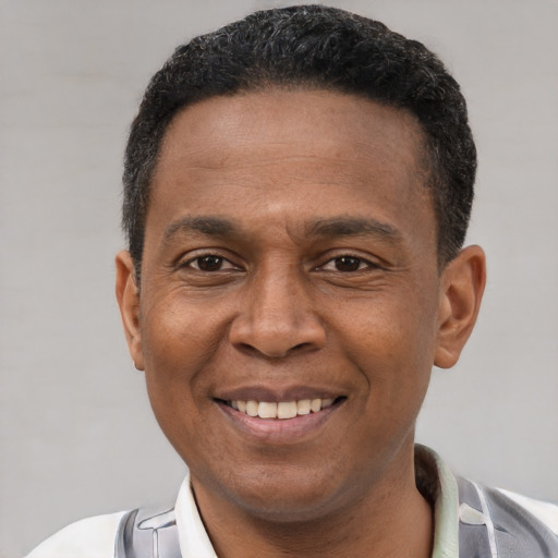 Joyful latino adult male with short  brown hair and brown eyes