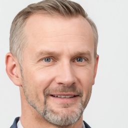 Joyful white adult male with short  brown hair and grey eyes