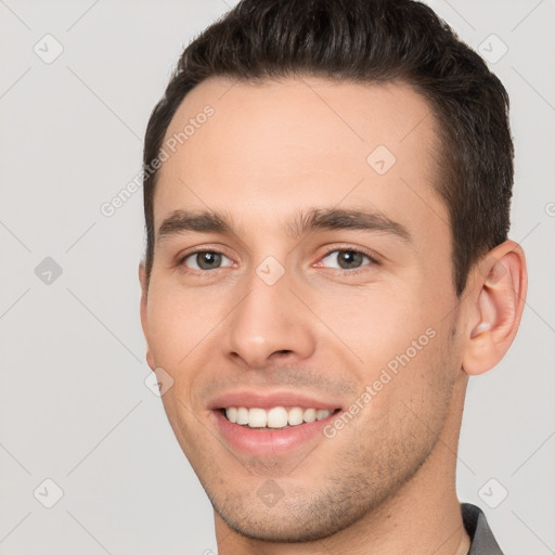 Joyful white young-adult male with short  brown hair and brown eyes