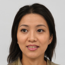 Joyful asian young-adult female with medium  brown hair and brown eyes