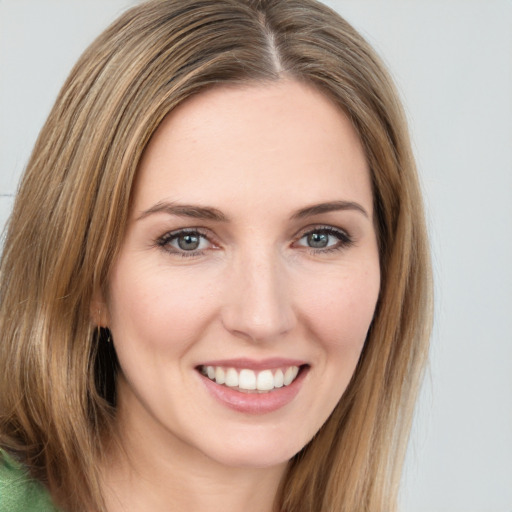 Joyful white young-adult female with long  brown hair and green eyes