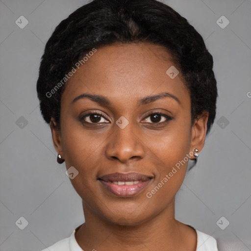 Joyful black young-adult female with short  black hair and brown eyes