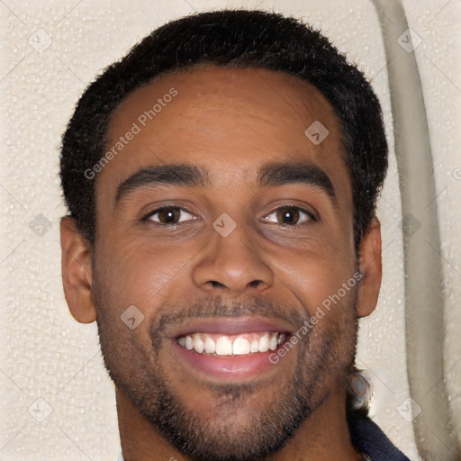 Joyful black young-adult male with short  brown hair and brown eyes