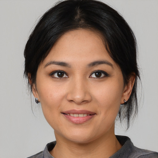 Joyful asian young-adult female with medium  black hair and brown eyes