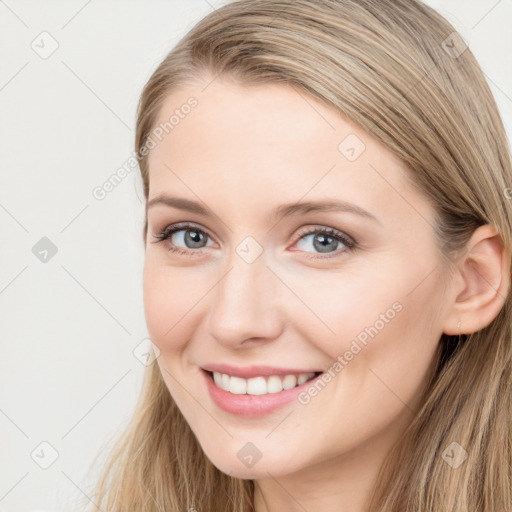 Joyful white young-adult female with long  brown hair and blue eyes