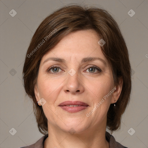 Joyful white adult female with medium  brown hair and grey eyes