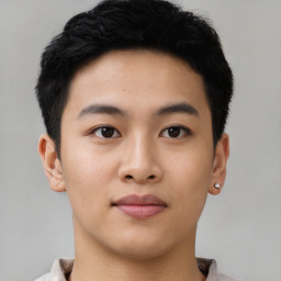 Joyful asian young-adult male with short  black hair and brown eyes