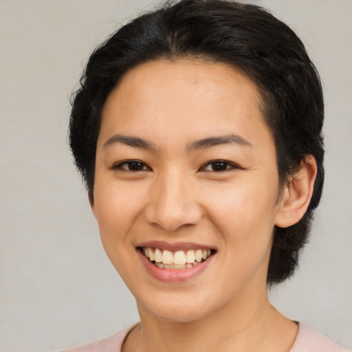 Joyful asian young-adult female with short  brown hair and brown eyes