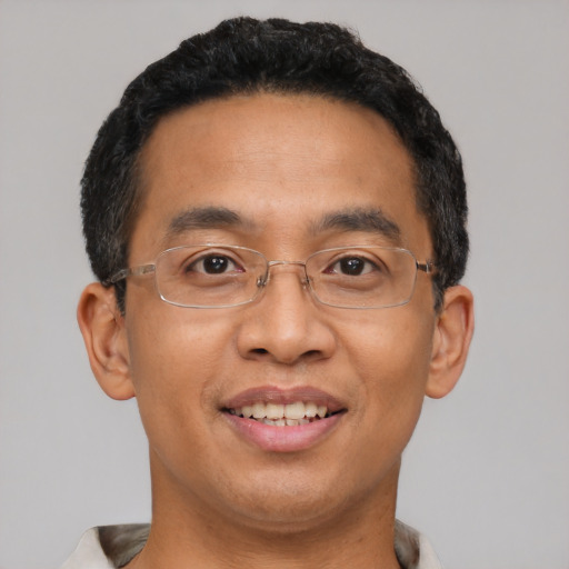 Joyful latino adult male with short  black hair and brown eyes