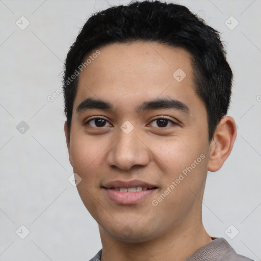 Joyful asian young-adult male with short  black hair and brown eyes