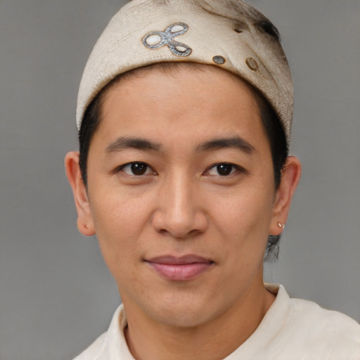 Joyful latino young-adult male with short  brown hair and brown eyes