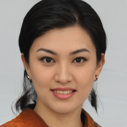 Joyful asian young-adult female with medium  brown hair and brown eyes