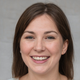 Joyful white adult female with medium  brown hair and brown eyes