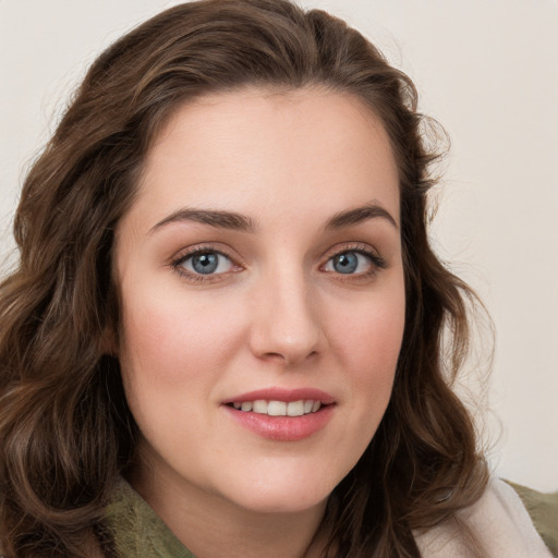 Joyful white young-adult female with long  brown hair and green eyes