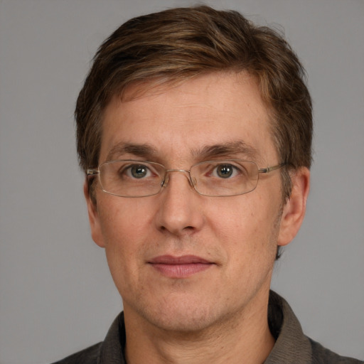 Joyful white adult male with short  brown hair and grey eyes