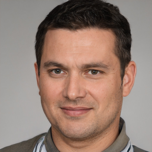 Joyful white adult male with short  brown hair and brown eyes