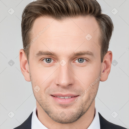 Joyful white young-adult male with short  brown hair and grey eyes