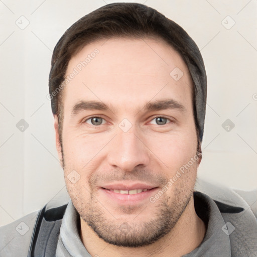 Joyful white young-adult male with short  brown hair and brown eyes