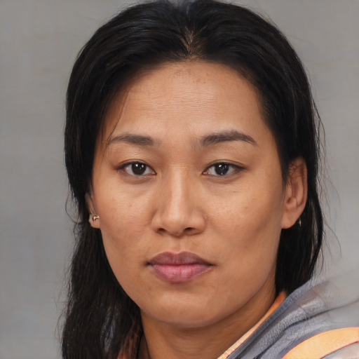 Joyful asian adult female with medium  brown hair and brown eyes