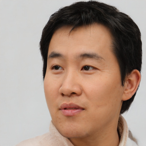 Neutral asian adult male with short  black hair and brown eyes